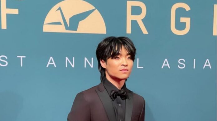 Avatar actor Dallas Liu in black suit