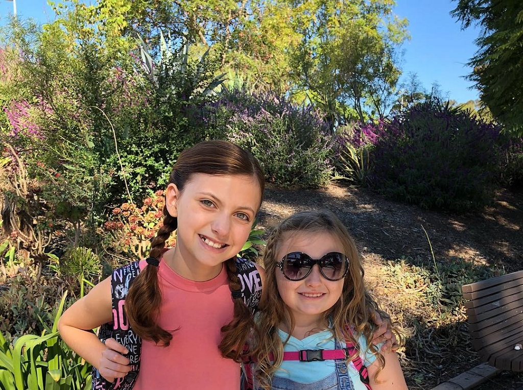 Kaylin with her sister smiling for the camera.